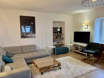 a living room with a couch and a flat screen tv at Appartement pour 14 pers, rénové, animaux acceptés, parking - FR-1-624-92 in Samoëns