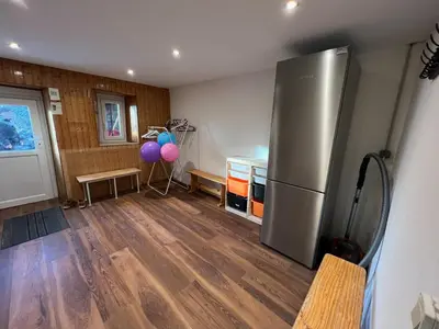 a kitchen with a stainless steel refrigerator and balloons at Appartement pour 14 pers, rénové, animaux acceptés, parking - FR-1-624-92 in Samoëns