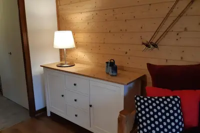 a table with a lamp on it next to a bed at Apartment With View On The Mont Blanc in Saint-Gervais-les-Bains