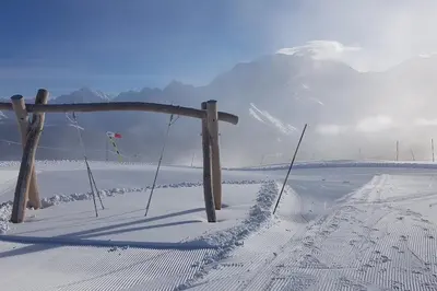 a fence in the snow with a mountain in the background at Apartment With View On The Mont Blanc in Saint-Gervais-les-Bains