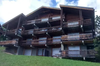 an apartment building with balconies on a hill at Apartment With View On The Mont Blanc in Saint-Gervais-les-Bains