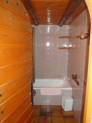 a bathroom with a tub and a toilet in it at Chalet Chez Nous in Domancy
