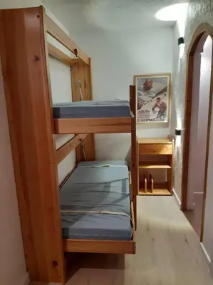 a room with three bunk beds in a room at Appartement meublé avec vue sur les montagnes et piscine l'été in Saint-Gervais-les-Bains