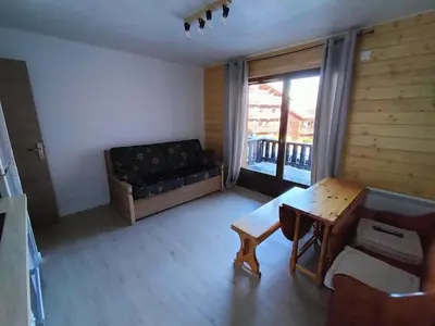 a living room with a couch and a table at Appartement meublé avec vue sur les montagnes et piscine l'été in Saint-Gervais-les-Bains