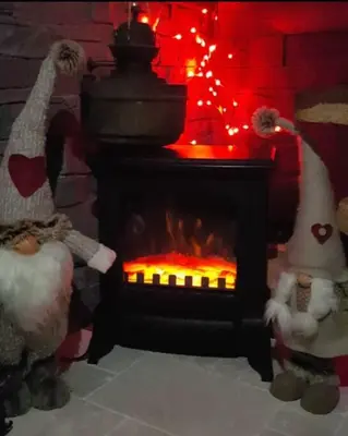 two stuffed animals are standing next to a fireplace at Calme et sérénité - établissement classé in Sixt