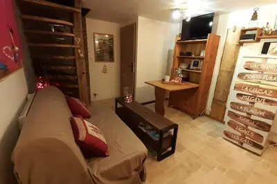 a living room with a couch and a table at Calme et sérénité - établissement classé in Sixt