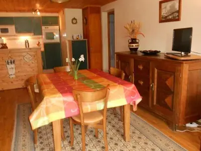 a dining room with a table and some chairs at La Tour in Combloux