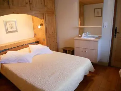 a bedroom with a bed and a sink at La Tour in Combloux