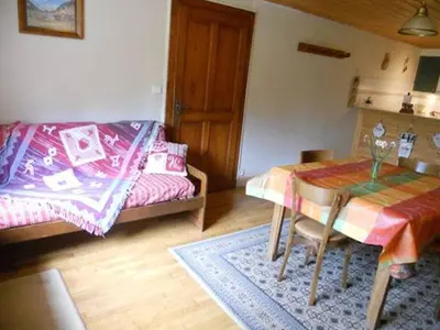 a living room with a table and a couch at La Tour in Combloux