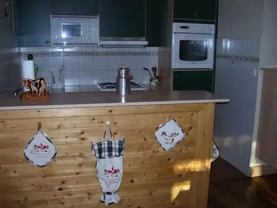 a kitchen with a counter and a stove top oven at La Tour in Combloux