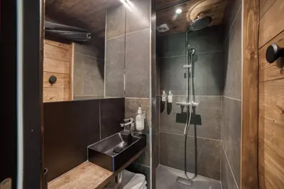 a bathroom with a sink and a shower at Le Chalet Georges in Chamonix-Mont-Blanc
