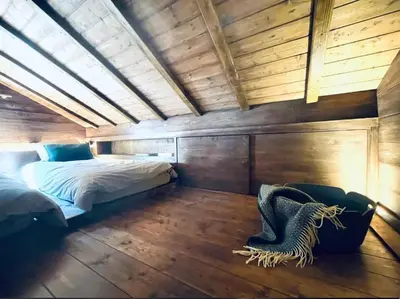 a bedroom with a bed in a room with wooden walls at Le Chalet Georges in Chamonix-Mont-Blanc