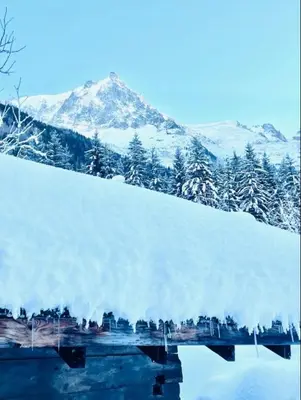 a pile of snow with a mountain in the background at Le Chalet Georges in Chamonix-Mont-Blanc