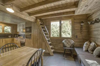a kitchen and dining room of a tiny house at Le Chalet Georges in Chamonix-Mont-Blanc