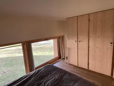 a bedroom with a bed and a large window at Résidence Grand Roc - Bruyères 20 in Chamonix-Mont-Blanc