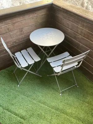 a table and two chairs and a table and chairs at Résidence Grand Roc - Bruyères 20 in Chamonix-Mont-Blanc