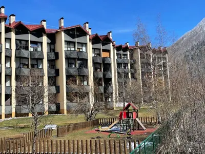 a playground in front of a large apartment building at Résidence Grand Roc - Bruyères 20 in Chamonix-Mont-Blanc