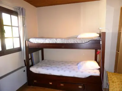 two bunk beds in a room with a window at Chalet Santa Claus - Chalet Santa Claus MAE-7284 in Les Contamines-Montjoie