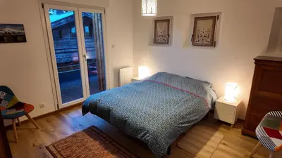 a bedroom with a bed and a sliding glass door at New Spacious Appart. Incredible view of Mt Blanc in Passy
