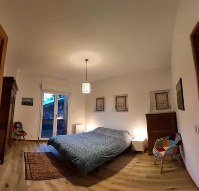 a bedroom with a bed and two chairs and a window at New Spacious Appart. Incredible view of Mt Blanc in Passy
