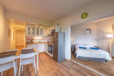 a kitchen and a bedroom with a bed and a table at Cocon du Lachat in Saint-Gervais-les-Bains