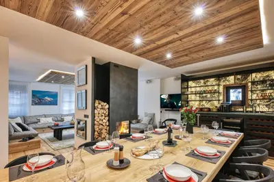 a dining room with a long table and chairs at Le Marti in Chamonix-Mont-Blanc
