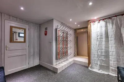 a hallway with a white door and a curtain at Le Marti in Chamonix-Mont-Blanc