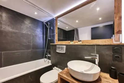 a bathroom with a sink and a toilet and a tub at Le Marti in Chamonix-Mont-Blanc