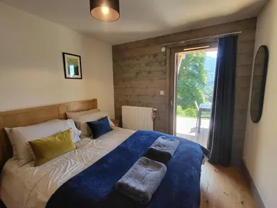 a bedroom with a bed with two pillows on it at Plein Soleil 3 bedroom apartment with stunning mountain views in Samoëns