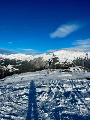 a shadow of a person standing on a snow covered mountain at Plein Soleil 3 bedroom apartment with stunning mountain views in Samoëns