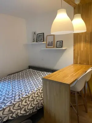 a bedroom with a bed and a table and a desk at Centre Saint-Gervais studio Jaune moderne proche télécabine 2 pers in Saint-Gervais-les-Bains