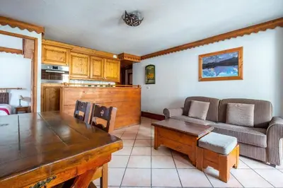 a living room with a table and a couch at Le Petit Paradis - Indoor pool and sauna in Chamonix-Mont-Blanc