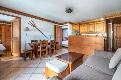 a living room with a couch and a table at Le Petit Paradis - Indoor pool and sauna in Chamonix-Mont-Blanc