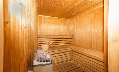 a wooden sauna with a bench inside of it at Le Petit Paradis - Indoor pool and sauna in Chamonix-Mont-Blanc