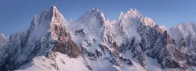 a mountain range with snow on its sides at Le Petit Paradis - Indoor pool and sauna in Chamonix-Mont-Blanc
