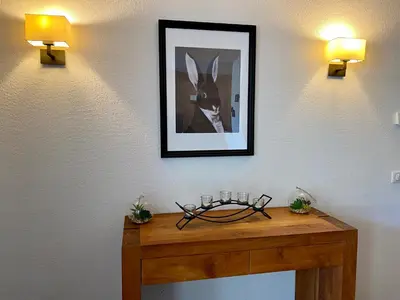 a table with a picture of a rabbit on a wall at Le REFUGE DES PORTES DU MONT BLANC in Vallorcine