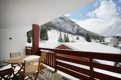 a balcony with a view of a snow covered mountain at Le REFUGE DES PORTES DU MONT BLANC in Vallorcine