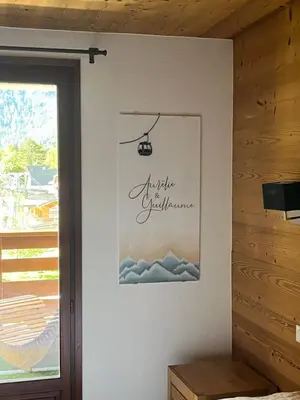 a picture on the wall of a room with a window at Le REFUGE DES PORTES DU MONT BLANC in Vallorcine