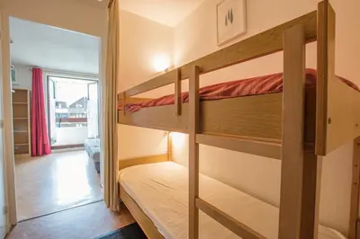 a bedroom with two bunk beds in a room at Studio Ella au cœur du village in Samoëns