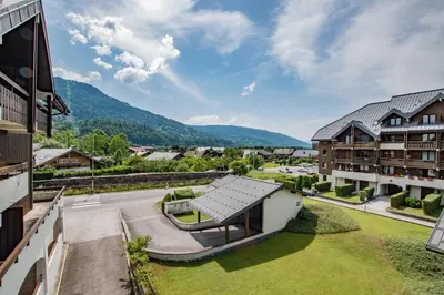 an aerial view of the courtyard of a house with mountains in the background at Studio Ella au cœur du village in Samoëns