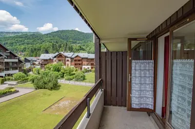 a balcony with a view of a yard at Studio Ella au cœur du village in Samoëns