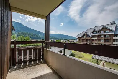 a balcony with a view of a building at Studio Ella au cœur du village in Samoëns