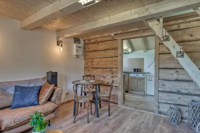 a living room with a couch and a table at Mazot savoyard situé à 25 kms de CHAMONIX in Saint-Gervais-les-Bains