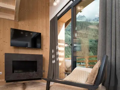 a room with a fireplace and a flat screen tv at La Cordee 623-Luxury apartment with mountain view and SPA in Chamonix-Mont-Blanc