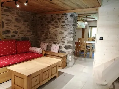 a living room with a red couch and a table at Chalet la corne du chamois in Sixt