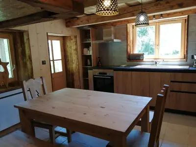 a kitchen with a wooden table and a sink at Chalet la corne du chamois in Sixt