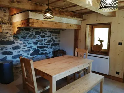 a dining room with a wooden table and chairs at Chalet la corne du chamois in Sixt