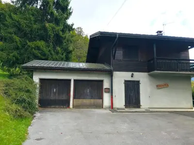 a house with two garage doors and a driveway at Chalet familial calme proche centre, 8 pers, WiFi, garage - FR-1-629-103 in Samoëns