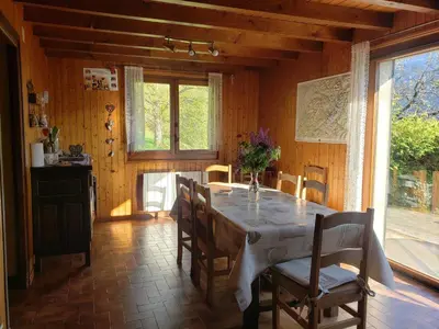 a dining room with a table and some chairs at Chalet familial calme proche centre, 8 pers, WiFi, garage - FR-1-629-103 in Samoëns