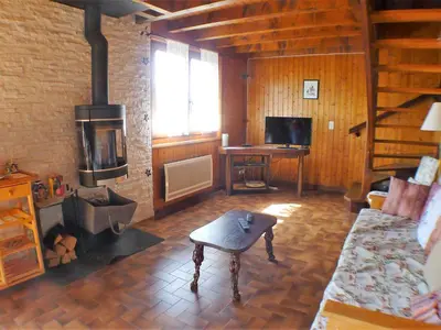 a living room with a fireplace and a room with a couch at Chalet familial calme proche centre, 8 pers, WiFi, garage - FR-1-629-103 in Samoëns